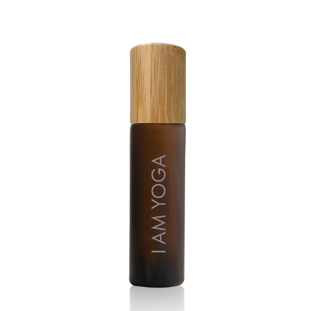 yoga perfume oil in an amber glass  bottle with bamboo lid