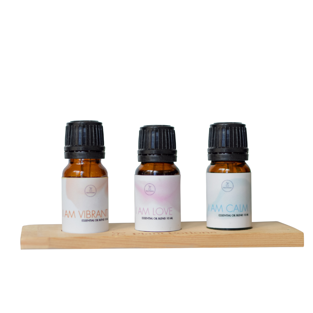 3 essential oil  lends on a wooden stand