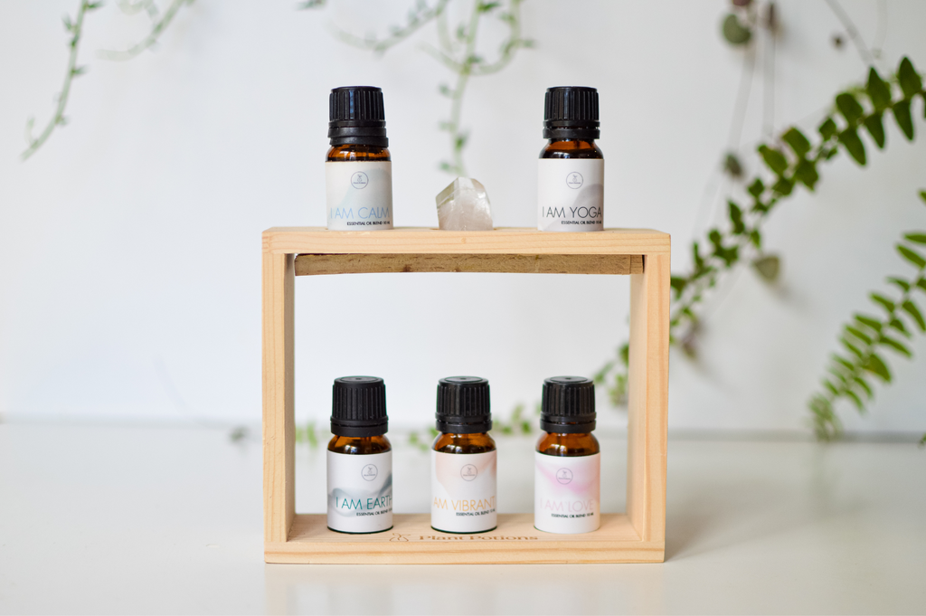 5 essential oil blends on a crystal inlaid wooden stand