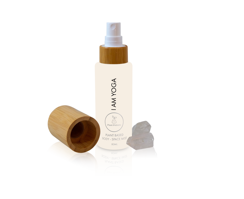 yoga body mist in a glass bottle with bamboo lid and clear quartz crystals